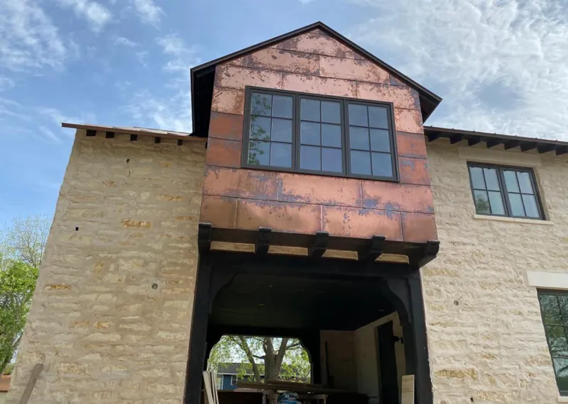 Copper metal panel facade on a stone building for Metal Roof Coating in Coal City